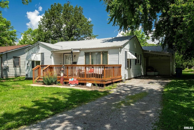 1013 Kirkpatrick St, Benton, IL 62812 - ranch-style home with dirt driveway, a deck, a front yard, metal roof, and a carport