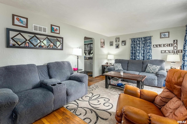 1013 Kirkpatrick St, Benton, IL 62812 - living room with arched walkways and wood finished floors