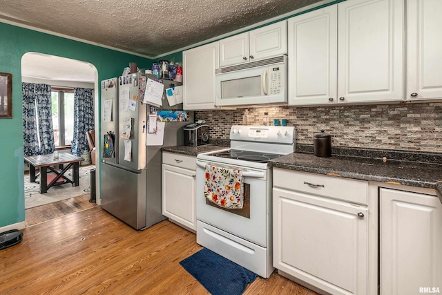 1013 Kirkpatrick St, Benton, IL 62812 - kitchen with white appliances, light wood finished floors, white cabinets, backsplash, and a textured ceiling
