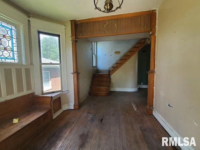 1043 19th St, Rock Island, IL 61201 - unfurnished living room with stairs, wood finished floors, and baseboards