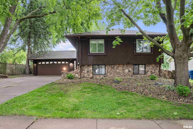 5721 Taylor St, Davenport, IA 52806 - tri-level home with an attached garage, stone siding, concrete driveway, and roof with shingles