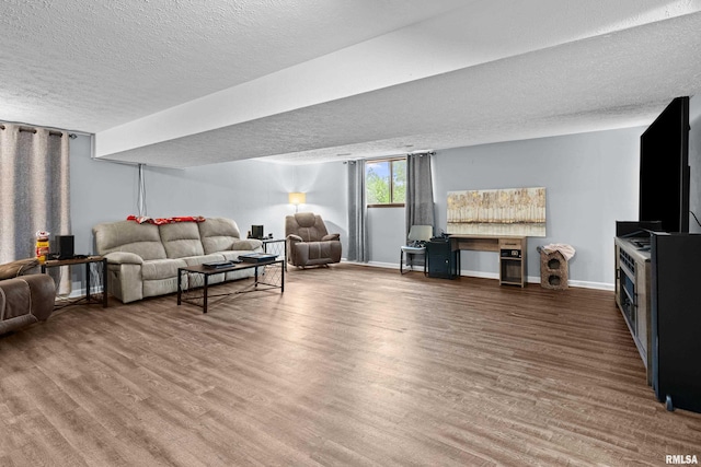 5721 Taylor St, Davenport, IA 52806 - living room featuring a textured ceiling, wood finished floors, and baseboards