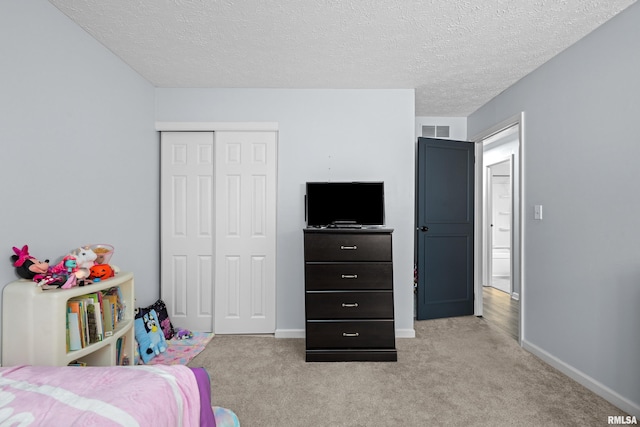 5721 Taylor St, Davenport, IA 52806 - bedroom featuring light carpet, a closet, baseboards, and a textured ceiling