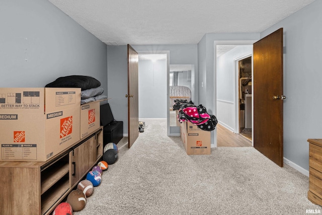 5721 Taylor St, Davenport, IA 52806 - game room featuring light colored carpet, a textured ceiling, and baseboards