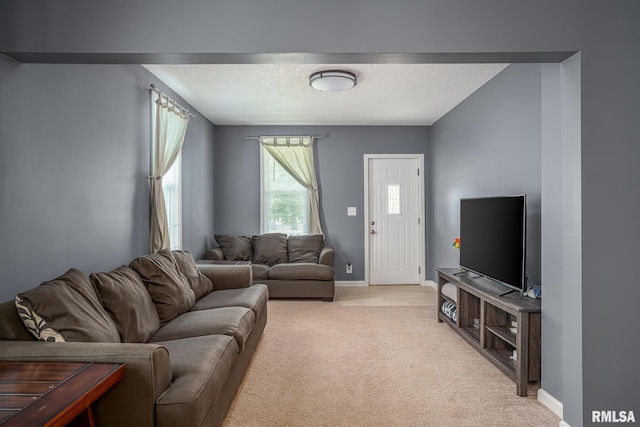 2612 7th St, Moline, IL 61265 - living room featuring light colored carpet, a textured ceiling, and baseboards