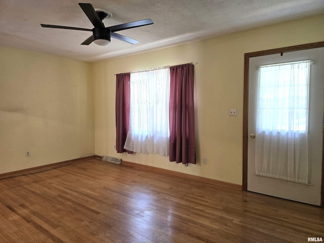1907 S 15th Ave, Clinton, IA 52732 - entryway featuring healthy amount of natural light, ceiling fan, wood finished floors, a textured ceiling, and baseboards