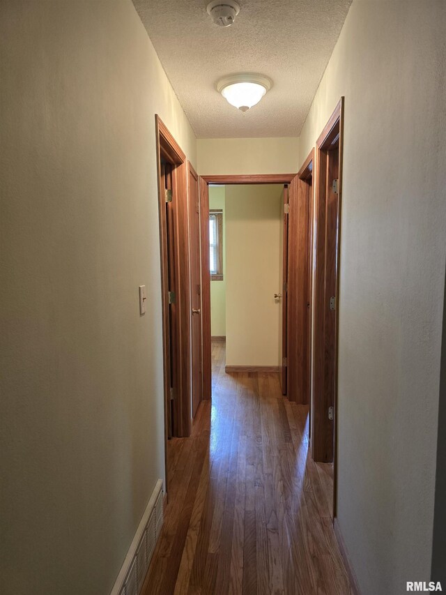 1907 S 15th Ave, Clinton, IA 52732 - corridor with a textured ceiling and wood finished floors