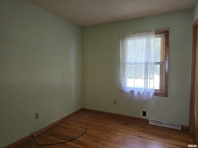 1907 S 15th Ave, Clinton, IA 52732 - spare room featuring wood finished floors and baseboards