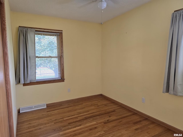 1907 S 15th Ave, Clinton, IA 52732 - unfurnished room with wood finished floors, a ceiling fan, baseboards, and a baseboard radiator