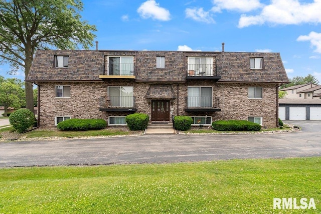 3069 4th St Unit 4, Moline, IL 61265 - view of front of home with brick siding, mansard roof, a balcony, and a front lawn
