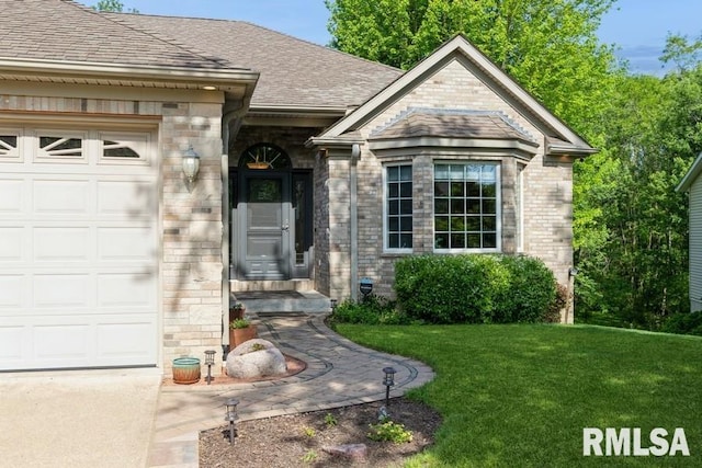 461 45th Ave, East Moline, IL 61244 - property entrance featuring a yard, a garage, roof with shingles, and brick siding
