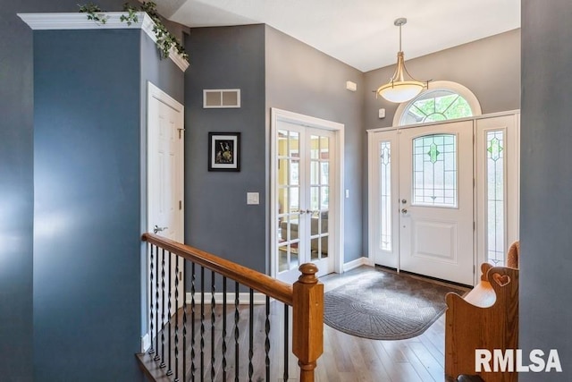 461 45th Ave, East Moline, IL 61244 - foyer entrance featuring wood-type flooring, french doors, a high ceiling, and baseboards