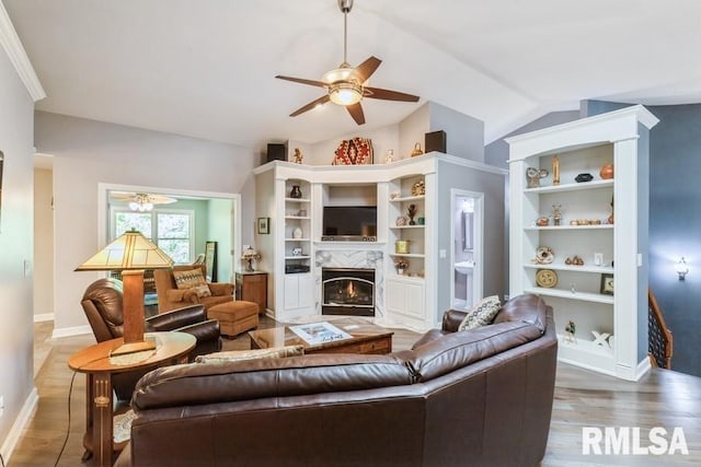 461 45th Ave, East Moline, IL 61244 - living room with ceiling fan, a high end fireplace, baseboards, built in features, and lofted ceiling