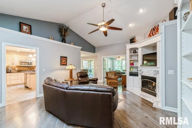 461 45th Ave, East Moline, IL 61244 - living area featuring ceiling fan, light wood finished floors, a fireplace, and lofted ceiling