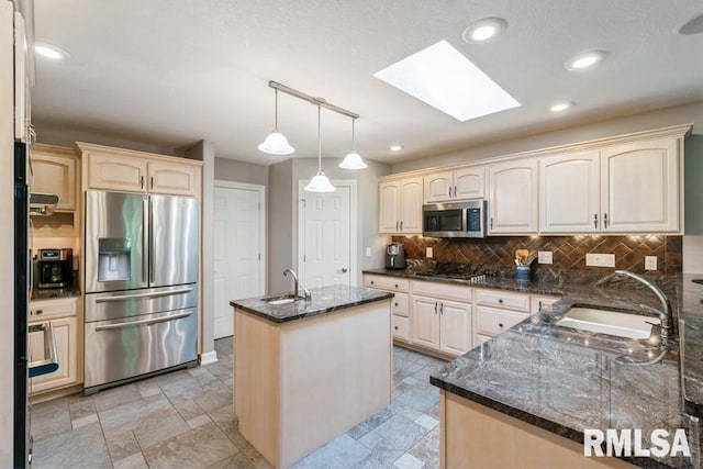 461 45th Ave, East Moline, IL 61244 - kitchen with stainless steel appliances, a sink, a skylight, an island with sink, and recessed lighting