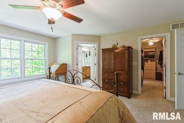 461 45th Ave, East Moline, IL 61244 - bedroom featuring a walk in closet, a closet, light colored carpet, ensuite bathroom, and baseboards