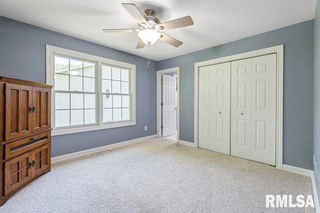 461 45th Ave, East Moline, IL 61244 - unfurnished bedroom with carpet flooring, a closet, baseboards, and a ceiling fan