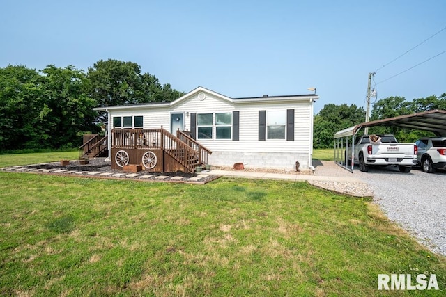 11271 W Center Rd, Mulkeytown, IL 62865 - manufactured / mobile home featuring stairs, driveway, a wooden deck, a front lawn, and a detached carport
