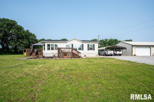 11271 W Center Rd, Mulkeytown, IL 62865 - manufactured / mobile home featuring a front lawn, gravel driveway, a detached carport, and a wooden deck