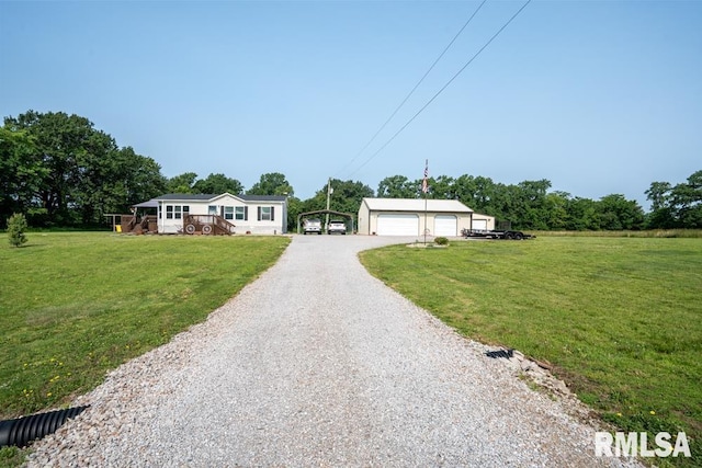11271 W Center Rd, Mulkeytown, IL 62865 - manufactured / mobile home with a garage, a front yard, and an outbuilding