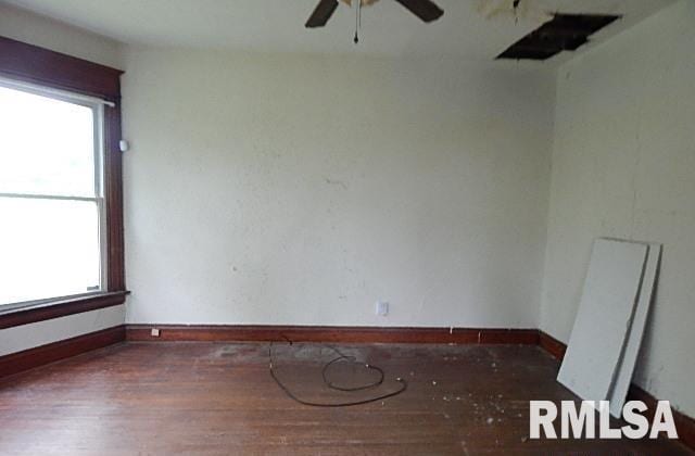 1132 W 9th St, Davenport, IA 52804 - spare room featuring a ceiling fan, wood finished floors, and baseboards