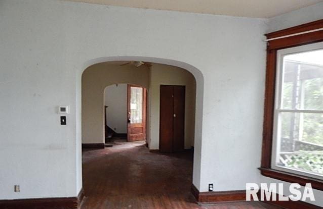 1132 W 9th St, Davenport, IA 52804 - hall with arched walkways, healthy amount of natural light, wood finished floors, and baseboards