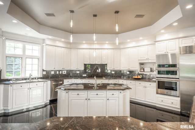 2 Hickory Ct, Rock Island, IL 61201 - kitchen featuring appliances with stainless steel finishes, a sink, recessed lighting, tasteful backsplash, and white cabinets