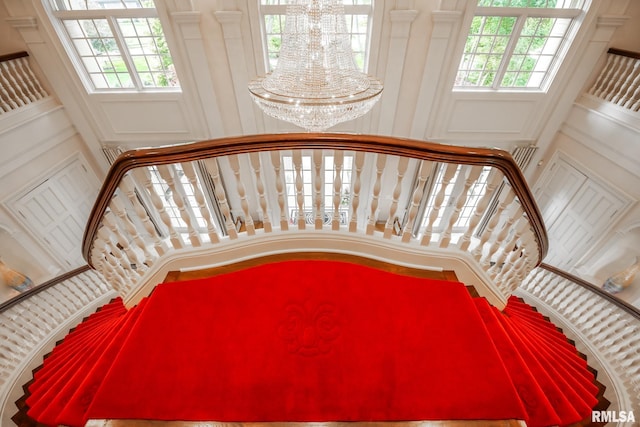 2 Hickory Ct, Rock Island, IL 61201 - stairway featuring a chandelier and a towering ceiling