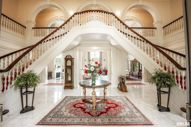 2 Hickory Ct, Rock Island, IL 61201 - foyer with a decorative wall, decorative columns, a high ceiling, stairs, and marble tiled floors