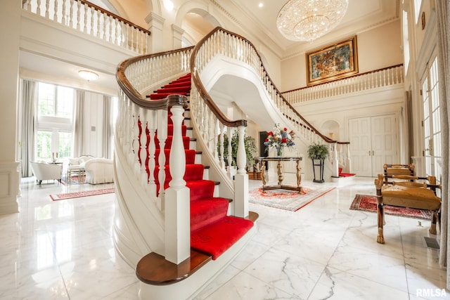 2 Hickory Ct, Rock Island, IL 61201 - entryway with a towering ceiling, marble tiled flooring, stairway, crown molding, and a chandelier