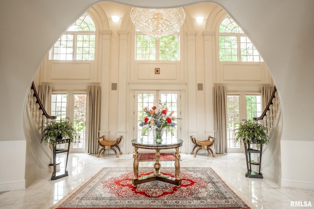 2 Hickory Ct, Rock Island, IL 61201 - entrance foyer with a towering ceiling, stairway, light marble finish floors, plenty of natural light, and a decorative wall