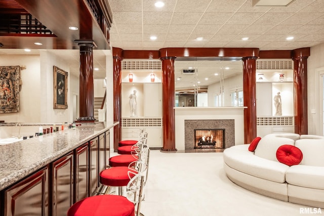 2 Hickory Ct, Rock Island, IL 61201 - living room featuring ornate columns, a warm lit fireplace, recessed lighting, and bar