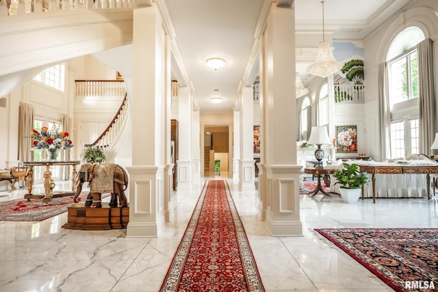 2 Hickory Ct, Rock Island, IL 61201 - hall featuring a decorative wall, light marble finish floors, decorative columns, a high ceiling, and a wainscoted wall