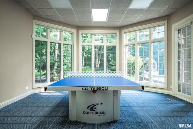 2 Hickory Ct, Rock Island, IL 61201 - recreation room with dark colored carpet, baseboards, and a drop ceiling