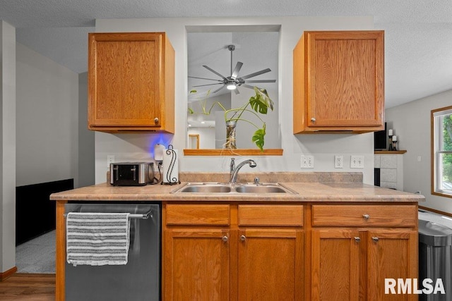 5300 Hillandale Rd, Davenport, IA 52806 - kitchen featuring dishwasher, a ceiling fan, light countertops, wood finished floors, and brown cabinetry