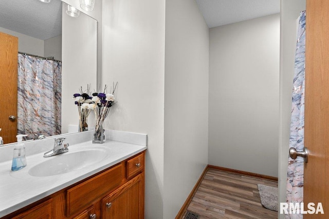 5300 Hillandale Rd, Davenport, IA 52806 - full bathroom with vanity, wood finished floors, and a textured ceiling