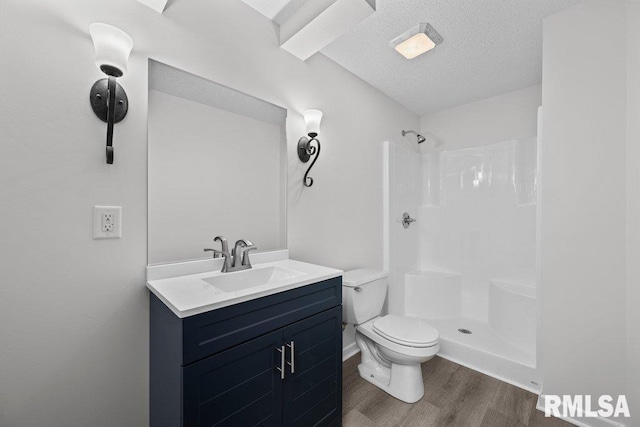 5300 Hillandale Rd, Davenport, IA 52806 - full bathroom with wood finished floors, a shower, vanity, and a textured ceiling