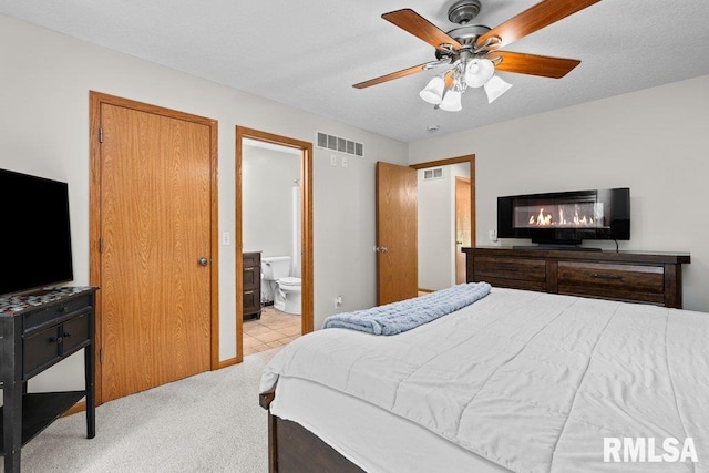 5300 Hillandale Rd, Davenport, IA 52806 - bedroom featuring light carpet, ensuite bath, and a ceiling fan