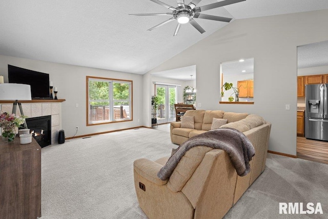 5300 Hillandale Rd, Davenport, IA 52806 - living area with light colored carpet, a ceiling fan, a tiled fireplace, and high vaulted ceiling