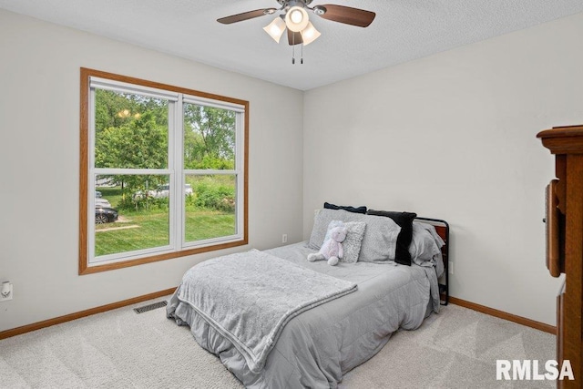 5300 Hillandale Rd, Davenport, IA 52806 - carpeted bedroom featuring a textured ceiling and a ceiling fan