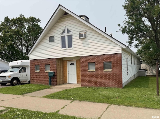 532 8th Ave S, Clinton, IA 52732 - view of front of property with brick siding, a front lawn, and a wall mounted AC