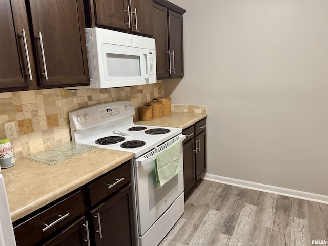 532 8th Ave S, Clinton, IA 52732 - kitchen with white appliances, dark brown cabinetry, backsplash, and light countertops