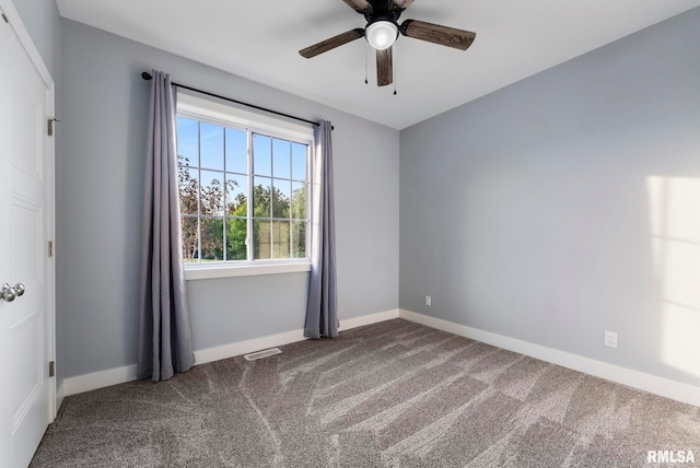 701 Sweet Wood Ln, Blue Grass, IA 52726 - spare room featuring carpet floors and ceiling fan