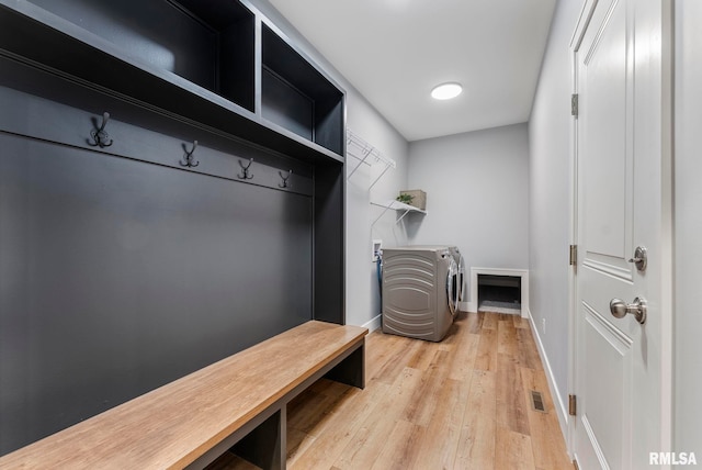 701 Sweet Wood Ln, Blue Grass, IA 52726 - mudroom with wood finished floors and washing machine and clothes dryer