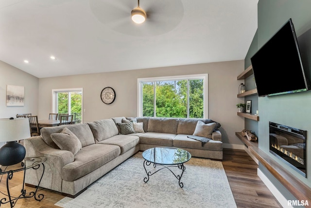 701 Sweet Wood Ln, Blue Grass, IA 52726 - living room with a ceiling fan, a glass covered fireplace, dark wood finished floors, vaulted ceiling, and recessed lighting