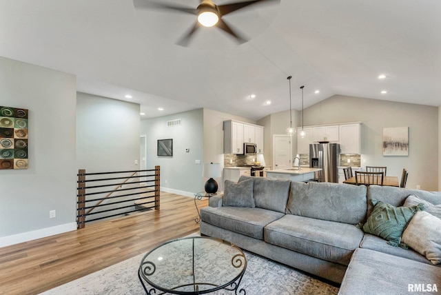 701 Sweet Wood Ln, Blue Grass, IA 52726 - living area with light wood finished floors, a ceiling fan, lofted ceiling, and recessed lighting