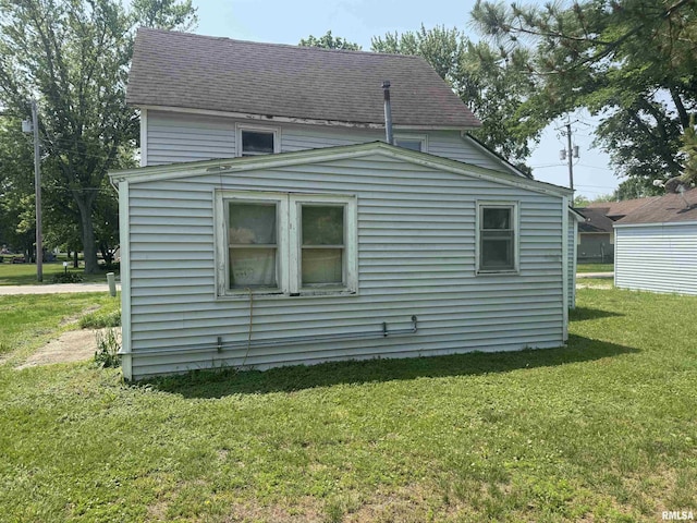 619 Green River St, Colona, IL 61241 - view of side of property featuring roof with shingles and a yard