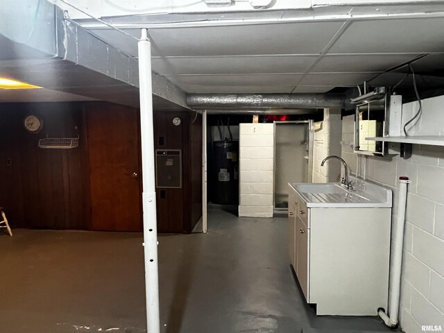 1210 Peterson Ave, Johnston City, IL 62951 - unfinished basement featuring water heater, concrete block wall, and a sink