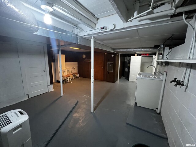 1210 Peterson Ave, Johnston City, IL 62951 - unfinished basement featuring washer / dryer, concrete block wall, and electric panel