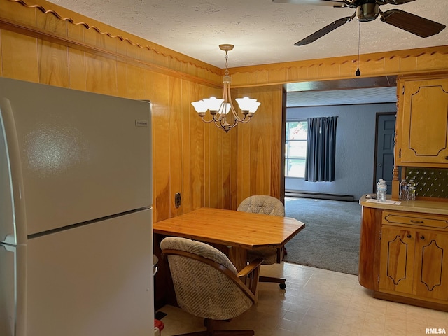 1210 Peterson Ave, Johnston City, IL 62951 - dining area featuring a chandelier, ceiling fan, a baseboard radiator, light flooring, and light carpet